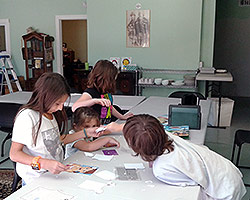children working on an art project at the main AQRT Center